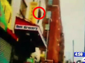 Caught on Tape - Man Jumps from Burning Building...and Gets Caught